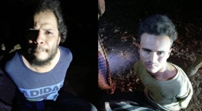 Two captured foreign ISIS militants, their faces visible, under Puntland military custody near Kalabayr, Somalia