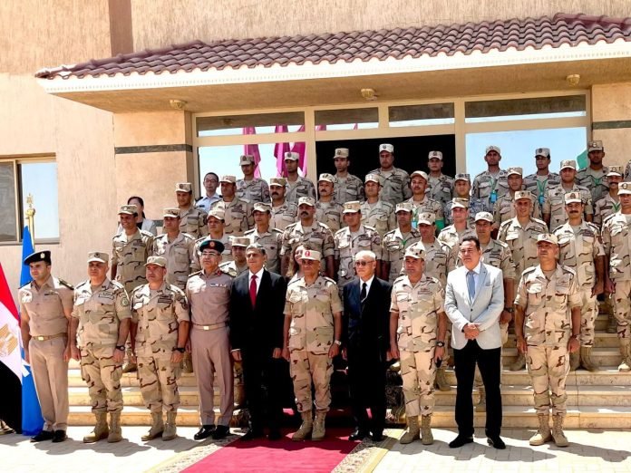 Group photo of Egyptian military officers and officials posing in front of a building before troop deployment to Somalia amid Ethiopia Nile dam tensions.